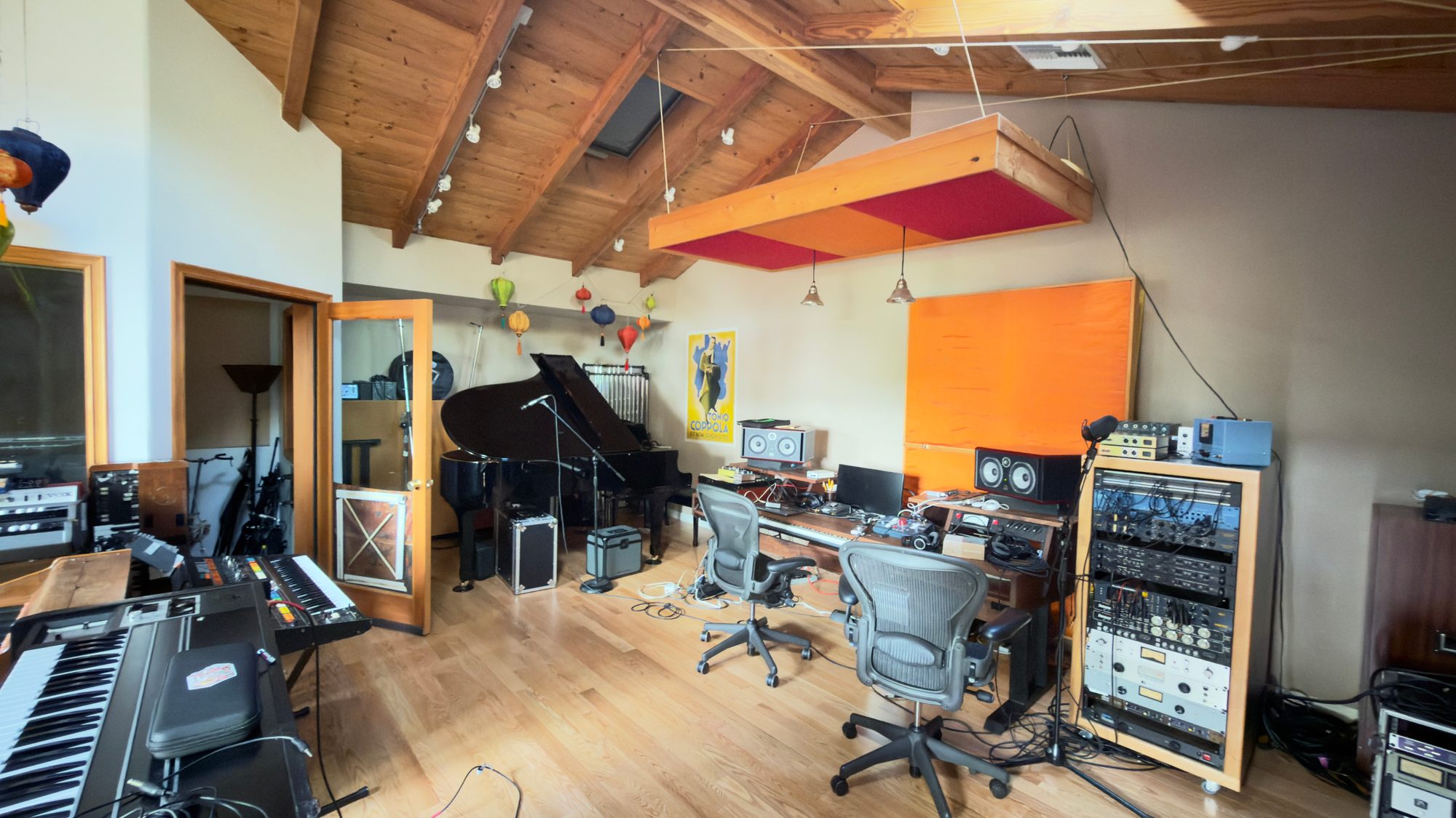 Mitchell Froom's studio, finished: grand piano, keyboards and the mix position under a pitched wood ceiling