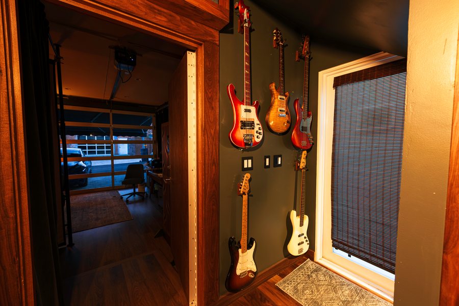Guitar wall by the entry
